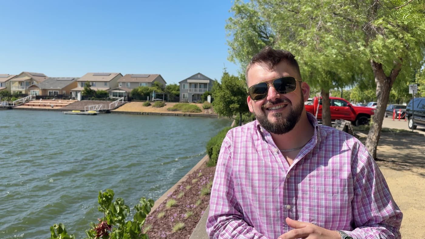 An Insta GQ client recording a video review outdoors by the water